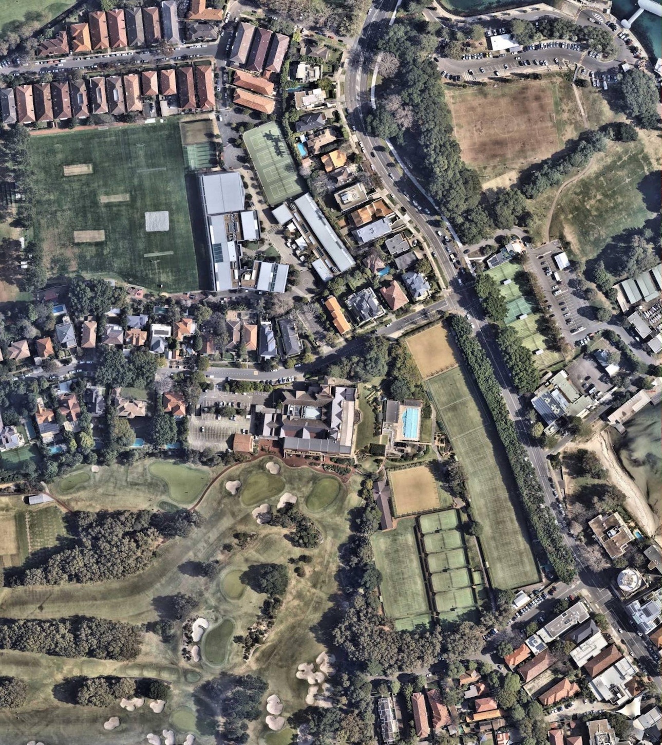 Visible-spectrum satellite photography of a residential and commercial urban area